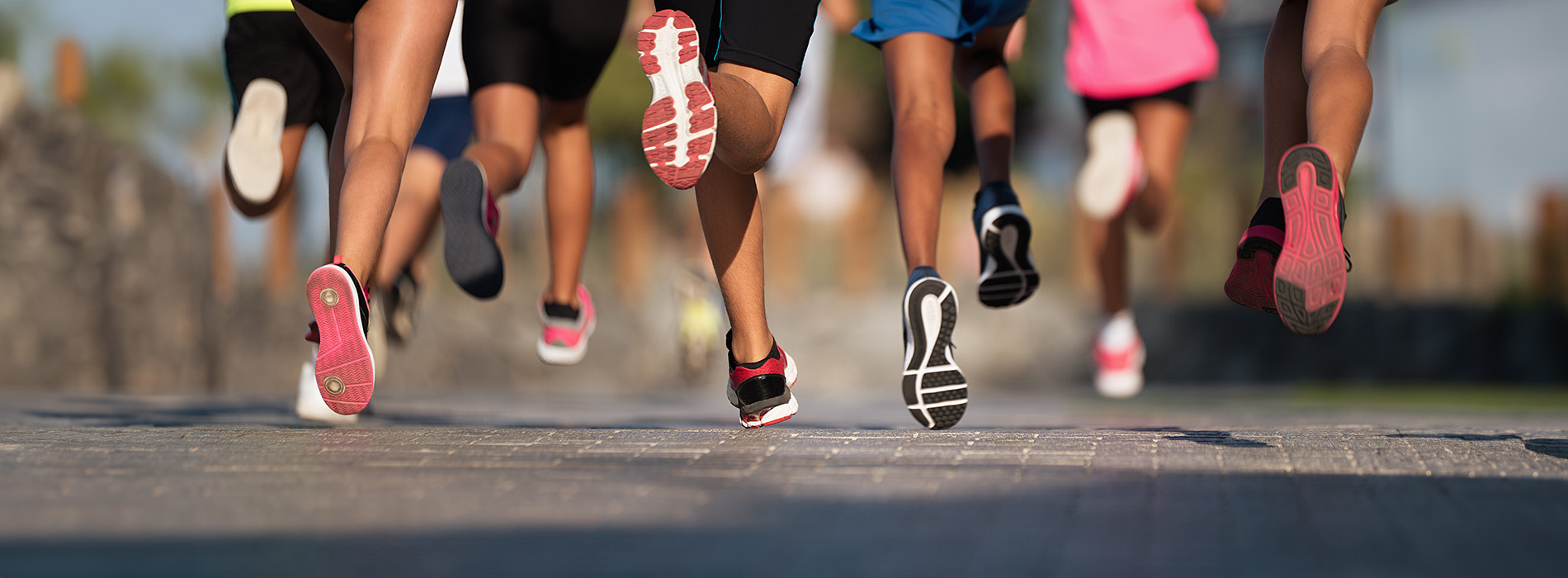 A group of runners participating in a race, with their feet off the ground, suggesting motion.